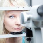 young woman having her eyes examined